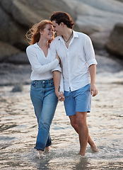 Image showing Love, romance and couple in the water at the beach holding hands while on a vacation together. Happy, smile and young man and woman walking in ocean or sea while on romantic weekend trip in Australia