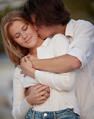 Image showing Love, kiss and couple hug, quality time and celebration with smile, relationship and affection. Romance, man or woman embrace, bonding or loving with joy, anniversary or romantic outdoor and cheerful