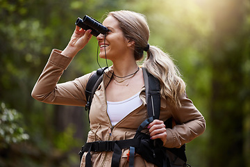 Image showing Binoculars, forest and hiking woman for travel journey, jungle adventure and nature explore with backpack and gear. Happy hiker or camper person trekking in woods and search or birdwatching outdoor