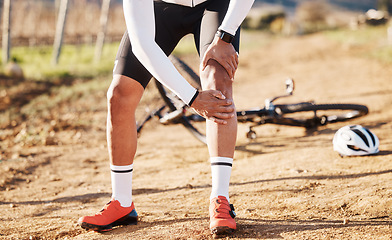 Image showing Injury, fitness and man with knee pain while cycling, cramp or inflammation during countryside cardio. Exercise, injured and biker with a sprain after a fall, accident or training for a competition