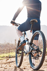 Image showing Back of man, bicycle and cycling in nature, countryside and training for triathlon, sports and flare. Cyclist, mountain bike and off road path for fitness, exercise and waiting on a break in sunshine