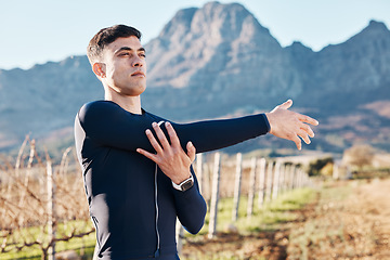 Image showing Man, stretching arms with run and fitness outdoor, nature view with hiking or running in countryside, exercise and warm up. Serious, muscle and strong male runner, start with marathon or trekking