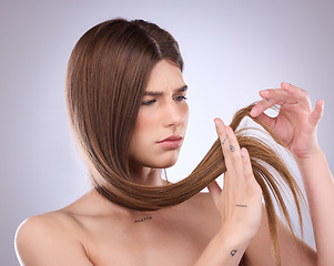 Image showing Face, beauty and hair loss of sad woman in studio isolated on a gray background. Angry, haircare and upset female model with keratin hairstyle problem, split ends and damage after salon treatment.