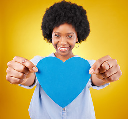 Image showing Paper, heart and portrait of black woman in studio for romance, positive and emotion. Happiness, love and giving with female isolated on yellow background for date, feelings and affectionate