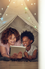 Image showing Tablet, black family and mother with kid in tent at night watching movie, video and having fun in home. Technology, love and smile of happy mixed race mom bonding with boy child while streaming film.