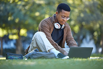 Image showing Black man, park studying and laptop work in a campus garden working on web education. Outdoor, happiness and online elearning with a textbook of a student busy with exam study on university grass