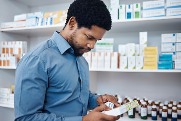 Image showing Pharmacy, shopping and man reading medicine box, customer supplements product or drugs store pharmaceutical. Retail hospital shop, clinic pills shelf and African client for medical healthcare choice