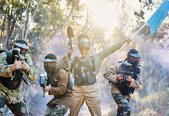 Image showing Teamwork, paintball and capture the flag in celebration for winning, victory or achievement standing together in nature. Group of paintballers rally up for win, success or checkpoint with guns ready