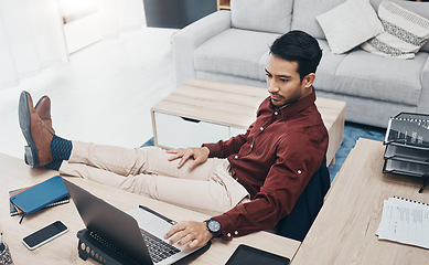 Image showing Work from home man with feet up on desk working on laptop for job confidence, productivity and online career. Asian remote worker, entrepreneur or professional person relaxing and typing on computer