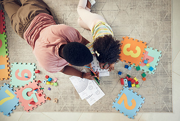 Image showing Home, toys and child with father support and helping with homework and coloring for school. Living room carpet, parent care and kid from above with dad and daughter with knowledge development