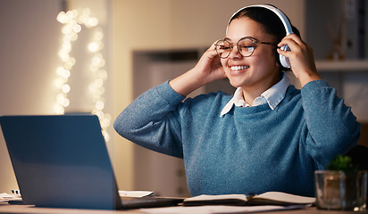 Image showing Laptop, music headphones and business woman in home at night streaming radio or podcast after working. Freelancer, remote worker and happy female listening or enjoying audio, song or album in house