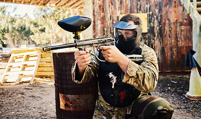 Image showing Paintball, target training or man with gun in shooting game playing with on fun battlefield mission. Aim, hero or focused soldier with army weapons gear for survival in outdoor challenge competition