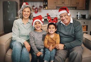 Image showing Portrait, christmas and grandparents on the sofa with their grandchildren in the living room as a family. Love, kids or celebration with a senior man, woman and kids together in their lounge