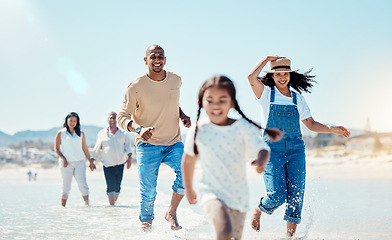 Image showing Family, beach and parents running with girl in water for bonding, quality time and adventure together. Travel, happy and mom, dad and grandparents with child enjoy summer holiday, vacation and relax