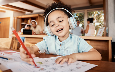 Image showing Distance learning, headphones and student doing homework while listening to music, audio book or radio. Home school, education of young kid or boy child writing on paper for academic or project