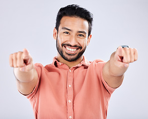 Image showing Portrait, pointing and motivation with a man in studio on a gray background choosing an option or selection. Happy, smile and hey you with a handsome young male making a choice or decision