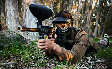 Image showing Paintball, gun and army crawl with a sports man on a battlefield for military or war training in nature. Fitness, team building and safety with a male athlete or soldier playing a game outdoor