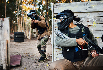 Image showing Sports, paintball and woman with gun for battle, game or competition outdoors on field. War fight, military army and female soldier with weapon on shooting range while hiding from player for exercise