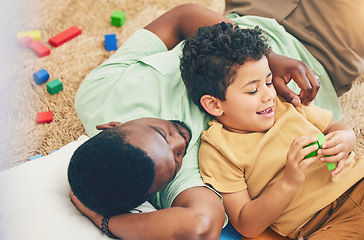 Image showing Relax, father and boy on floor with toys for playing, creative activity and fun bonding in living room. Education, child development and kid enjoy building blocks, games and relax with dad at home