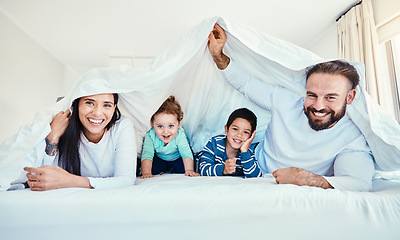 Image showing Family, portrait and blanket fort in bed with children and parents, happy and playing in their home. Face, under and sheet by kids with mom and dad in bedroom, fun and waking up, relax and smile