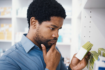 Image showing Black man, shopping or box in pharmacy for medicine, reading or pills in retail healthcare in store. African customer, decision or sale for health, deal or thinking for benefits of medical product