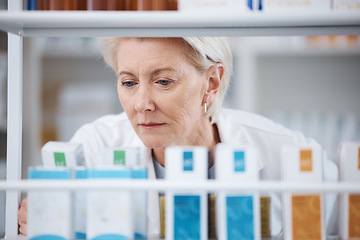 Image showing Senior woman, shop stock and pharmacist check shelf in a pharmacy for drug information. Healthcare, wellness and working elderly person with pharmaceutical drugs reading box product ingredients