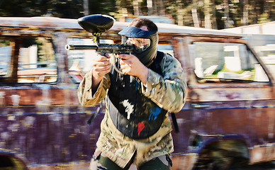 Image showing Aim, shooting and paintball man with gun for outdoor battlefield, playground or games in forest adventure training. Target skill of male player or sports person in military focus and survival mission