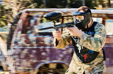 Image showing Target, shooting and paintball man with gun for outdoor battlefield, playground or games in grunge adventure training. Aim skill of male player or sports person in military focus and survival mission