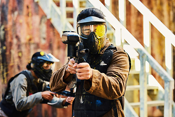 Image showing Paintball, person shot with paint and gun, helmet for safety on shooting range and war game for sports. Soldier with weapon on battlefield, action and camouflage uniform with adventure and target