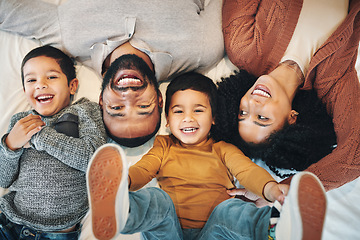 Image showing Happy, above and portrait of a family on a bed for relaxation, bonding and quality time. Laughing, smile and carefree parents with children in the bedroom to relax and play in the morning together