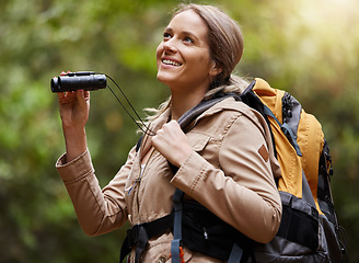 Image showing Nature, hiking and woman with binoculars, adventure trail on holiday in African game reserve. Trekking, trees and forest hike, sightseeing and person with smile on happy mountain walk in South Africa