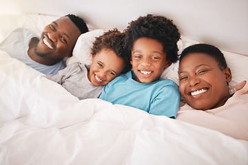 Image showing Smile, happy and relax with black family in bedroom for bonding, wake up and morning routine from top view. Care, funny and cute with parents and children at home for calm, weekend and quality time