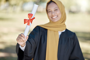 Image showing Graduation, university diploma and Muslim woman with award for success, ceremony and achievement. Education, college and happy graduate smile with certificate, degree and academy scroll on campus