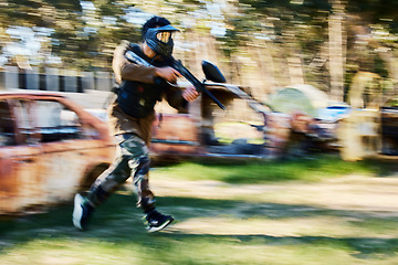 Image showing Paintball, blurry action or man running in shooting game with speed or fast motion on fun battlefield. Mission focus, moving or war soldier with gun for survival in competition in nature or forest