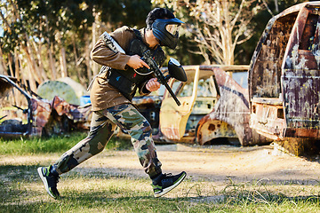 Image showing Paintball player or man running with gun, outdoor competition or games in forest adventure or military training. Army skill, fitness or sports person in shooting battlefield, action or target mission