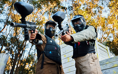 Image showing Paintball, sports teamwork and men with gun for game, battle or competition. Collaboration, portrait or cooperation of people or friends on shooting range ready for target, aim practice and training