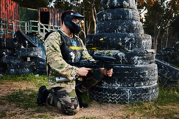 Image showing Paintball, gun and camouflage with a sports man on a battlefield for military or war training for the army. Fitness, team building and safety with a male athlete or soldier playing a game outdoor