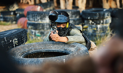 Image showing Paintball, person aim gun at target and military tactics, shooting range and war game for sports outdoor. Soldier with weapon on battlefield, action and camouflage, helmet for safety and adventure