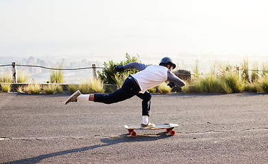 Image showing Skateboard, moving and man in road for sports competition, training and exercise in urban city. Skating, skateboarding and male skater in action for speed, adventure and freedom for extreme sport