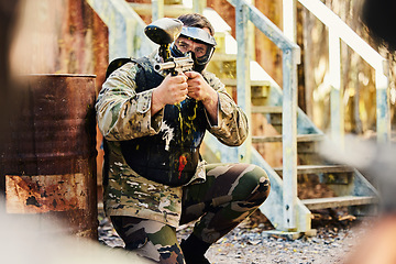 Image showing Paintball, target training or male soldier with gun in shooting game playing with on fun battlefield mission. Aim or focused man with army weapons gear for survival in outdoor challenge competition