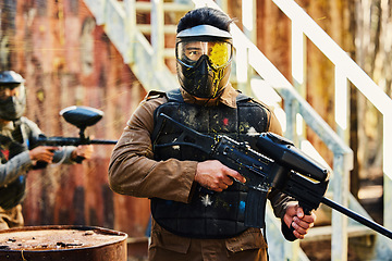 Image showing Portrait, paintball or man with gun in a game or competition for fitness, exercise or cardio workout. Focus, challenge or serious male athlete carrying an army weapon or marker for military training