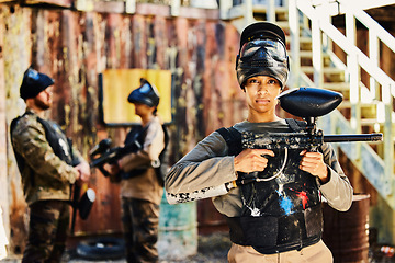 Image showing Portrait, paintball or woman with gun in game or competition for fitness, exercise or cardio workout. Focus, challenge or serious girl carrying an army weapon or marker for military target training