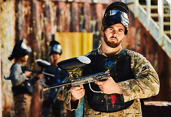 Image showing Paintball, serious or portrait of man with gun in shooting game playing in action battlefield mission. War, hero or focused soldier with army weapons gear in survival military challenge competition