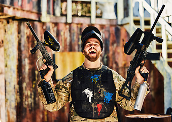Image showing Paintball, laughing or portrait of happy man with guns in shooting game playing or celebrates battlefield mission. Crazy or funny soldier with army weapons gear winning military challenge competition