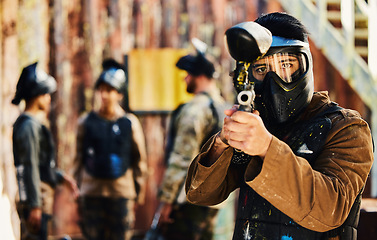 Image showing Paintball, focus or portrait of man with gun in shooting game playing in action battlefield mission. War, hero or focused soldier with army weapons gear in survival military challenge competition