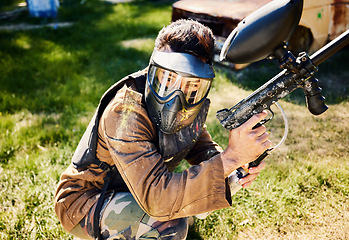 Image showing Paintball, target practice or male with gun in shooting game playing with on war battlefield mission. Army training or focused soldier with weapons gear in survival military challenge competition