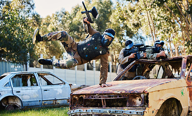 Image showing Car, jump or man in paintball shooting game playing with speed or fast action on fun battlefield. Mission focused, military or player running with guns gear for survival in an outdoor competition