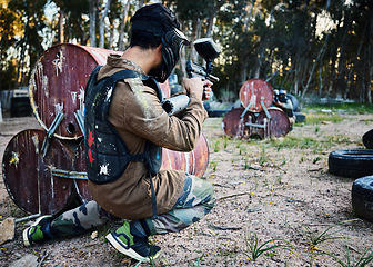 Image showing Paintball, gun and shooting with a sports man on a battlefield for military or war training for the army. Fitness, team building and safety with a male athlete or soldier playing a game outdoor