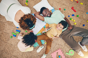 Image showing Top view, family and parents with children on floor with toys, number puzzle and bonding at home. Happy, educational games and mom, dad and kids smile for fun activity, creative learning and relax