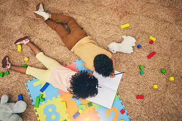 Image showing Drawing, book and top view of children on floor with toys, number puzzle and playing together at home. Family, educational games and happy boy and girl do fun activity, creative learning and relax